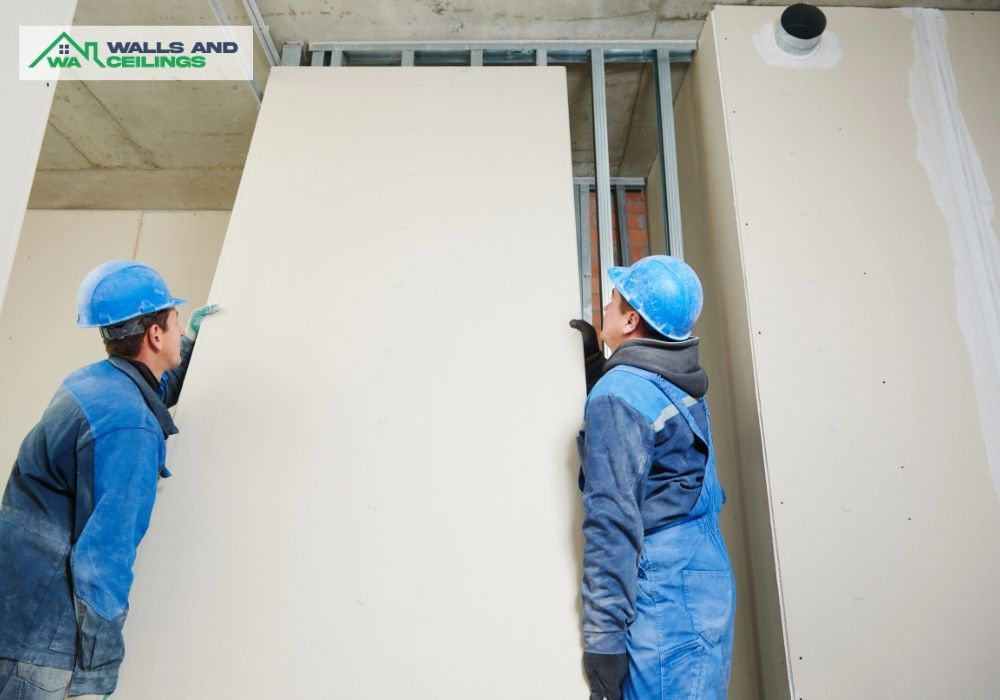 Workers holding gyprock for wall installation in Mindarie, Perth